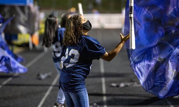 Color Guard member catches flag